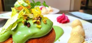 a piece of food with nuts on top on a plate at Sotto Il Cielo Hotel in Pignola
