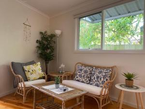 a living room with two chairs and a table at Invy Escape in Inverloch