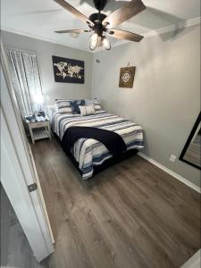 a bedroom with a bed and a ceiling fan at Sea Chase with an ocean view at Casa Del Mar in Galveston