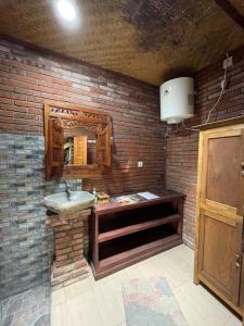a bathroom with a sink and a brick wall at Bulian Homestay in Kubutambahan +77 photos
