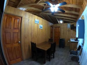 a room with a table and a ceiling fan at Laureles Collection Uvita - Cabinas Los Laureles in Uvita