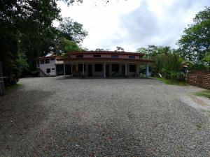 a house with a gravel driveway in front of it at Laureles Collection Uvita - Cabinas Los Laureles in Uvita