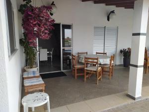 a dining room with a table and chairs at Chácara Atibaia in Atibaia