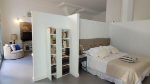 ein Schlafzimmer mit einem Bett und einem Bücherregal in der Unterkunft Vivaterra Apartments - San Telmo in Buenos Aires