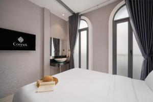 Tempat tidur dalam kamar di Mari Queen Hotel