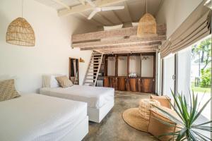 a hotel room with two beds and a staircase at Global Surf Lodge Kabalana in Ahangama