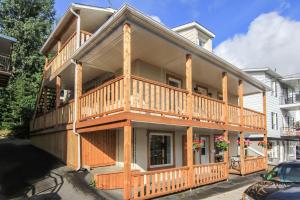a large wooden house with a balcony at L'escale du routard in Alma