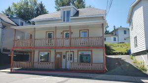 a large house with a balcony on a street at L'escale du routard in Alma