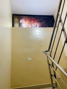 a staircase with a painting on the top of a wall at sonai POWERED BY PEACEFUL STUDIO in Panvel