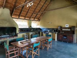 a large kitchen with a wooden table and chairs at El Morado Guest Farm in White River