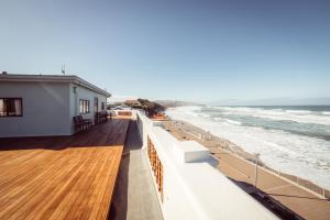 a balcony with a view of the beach at The Hydro Esplanade Apartments in Dunedin