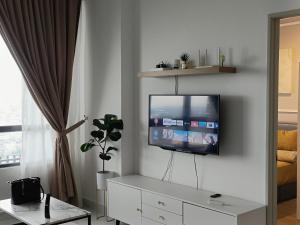 a living room with a flat screen tv on a wall at BR Troika Homestay in Kota Bharu