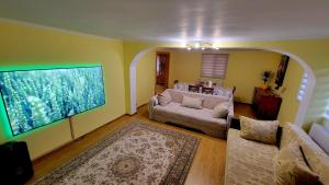 a living room with a large aquarium on the wall at Casablanca in Podu Dîmboviţei