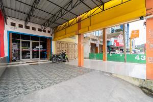 an empty building with motorcycles parked inside of it at RedDoorz At Fella Homestay Medan in Medan
