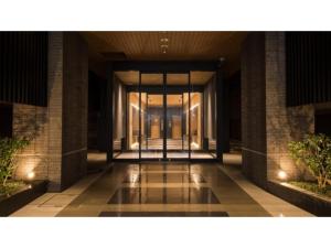 an empty hallway of a building with glass doors at Tmark City Hotel Kanazawa - Vacation STAY 90395v in Kanazawa