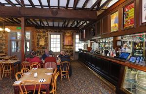 a restaurant with people sitting at tables and a bar at Keilor Motor Inn in Keilor