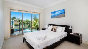 1 dormitorio con cama grande y ventana grande en Unit 13 - 3 Bedroom Ocean View, en Terrigal