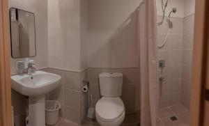 a small bathroom with a toilet and a sink at City View at The Persimmon Studios in Cebu City