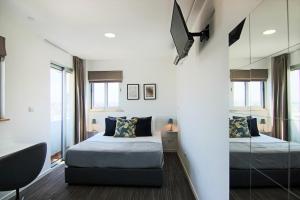 a bedroom with two beds and a mirror at Phaedrus Living: Luxury Suite Nicosia 510 in Nicosia