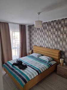 a bedroom with a bed with a black shirt on it at Best View Apartment in Braşov