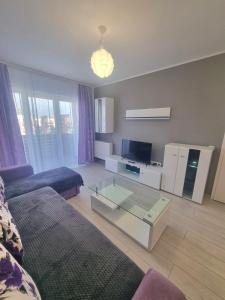 a living room with a couch and a glass coffee table at Best View Apartment in Braşov