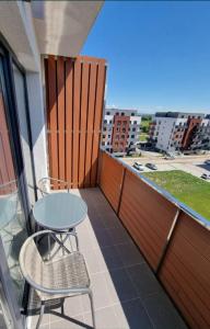 a patio with a table and chairs on a balcony at Best View Apartment in Braşov