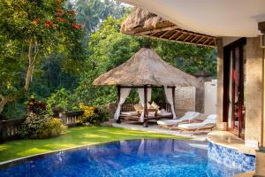 a resort with a swimming pool and a gazebo at Viceroy Bali in Ubud