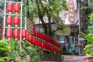 a row of red lanterns on the side of a building at Jenq Yang Hotspring Hotel in Renai