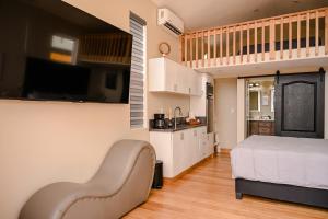 a small bedroom with a bed and a kitchen at Ariels Paraiso- Ocean view in Primo Tapia