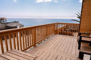 a wooden deck with a view of the ocean at Ariels Paraiso- Ocean view in Primo Tapia