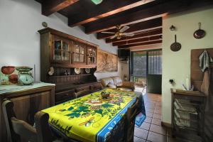 a kitchen with a table with a yellow table cloth on it at Appartamento Panoramico sul Mare in Buggerru