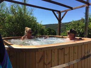 a man and a woman in a hot tub at Casa Traca in Valbona