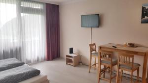 Televízia a/alebo spoločenská miestnosť v ubytovaní Apartment Wolfgangsee + 4 fotografie