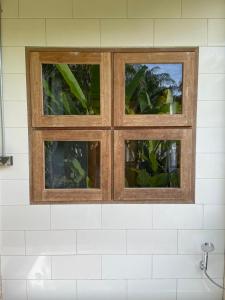 two windows above a sink in a bathroom at Forest Guesthouse in Ban Don Muang