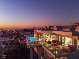 an aerial view of a house with a sunset at THE VIEW LANGEBAAN LAGOON VILLA WITH HEATED POOL and SOLAR ENERGY in Langebaan