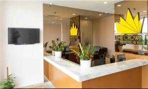 an office with a reception counter with potted plants at THE CROWN HOTEL @ KLIA in Sepang