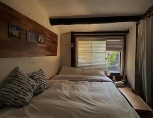 a bedroom with two beds and a window at Viva La Vida - Jongno Hanok Private House in Seoul