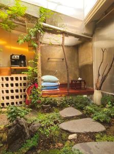 a garden with a bench in the middle of a room at Viva La Vida - Jongno Hanok Private House in Seoul