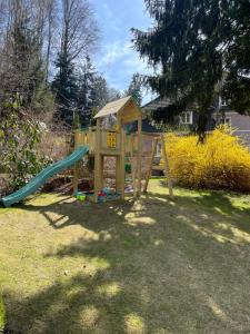 a playground in a yard with a slide at Apartmány Klicperka in Liberec