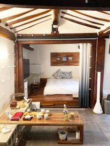 a bedroom with a bed and a table in a room at Viva La Vida - Jongno Hanok Private House in Seoul
