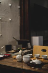 a wooden table with bowls and cups on it at Viva La Vida - Jongno Hanok Private House in Seoul