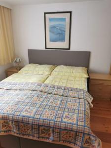 a bedroom with a bed with a quilt on it at Haus am Bach in Kirchberg in Tirol