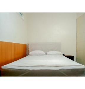 מיטה או מיטות בחדר ב-Homestay Akik Hijau Near Panakkukang