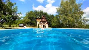 a house with a swimming pool in front of a house at Apartman Brezuljak Banja Luka Cokorska polja in Macanovići
