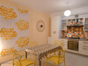 a kitchen with a table and chairs in a room at Icaro in Letojanni