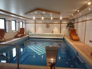 a large swimming pool with a bed in a room at Gasthof Zur Krone in Mitteleschenbach