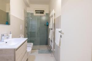 a bathroom with a shower and a sink and a toilet at Villa Peter in Ostuni +27 photos