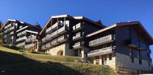 a large building on top of a hill at Courchevel 1550 - SUPERBE appartement SKIS AUX PIEDS ! in Courchevel