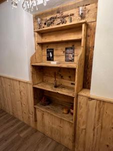 a wooden book shelf in the corner of a room at La Dorbluche apartment 4-6 person in Longefoy