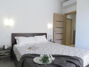 a bedroom with a bed with a plate of flowers on it at Pasubio Apartment in Bologna